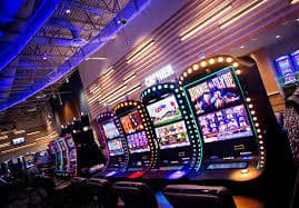 Mobile phone showing totowin 567.com app interface with live football betting, casino tables, and slot games